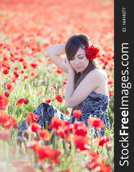 Young candid girl surrounded by poppies. Young candid girl surrounded by poppies.