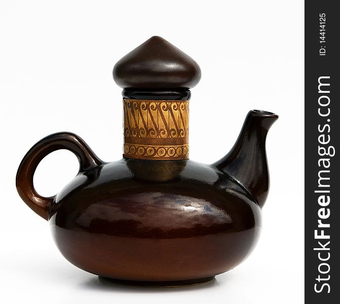 Israeli glazed ceramic teapot of 1950-th years in dark brown tones. The form and decor is typical for the oriental culture. Isolated on white. Israeli glazed ceramic teapot of 1950-th years in dark brown tones. The form and decor is typical for the oriental culture. Isolated on white.