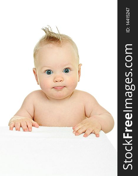 Eight month baby leans his hands against white surface. Eight month baby leans his hands against white surface