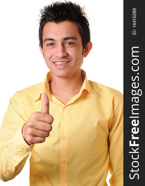 Smiling South Asian young businessman showing thumbs up