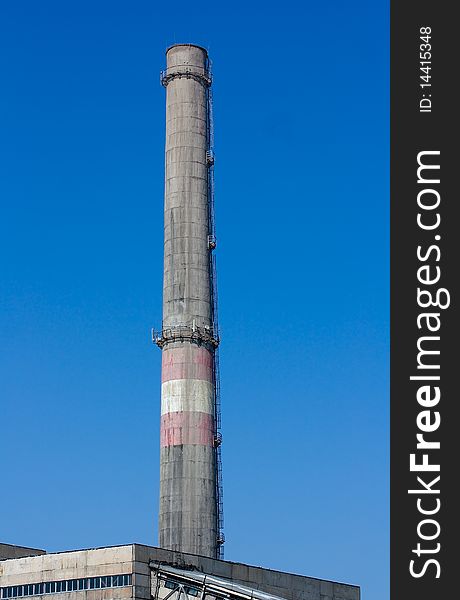 Chimney pipe against the blue sky