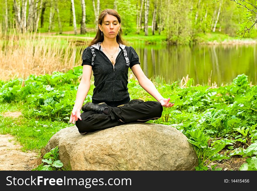Young woman meditating and relaxing in forest. Young woman meditating and relaxing in forest