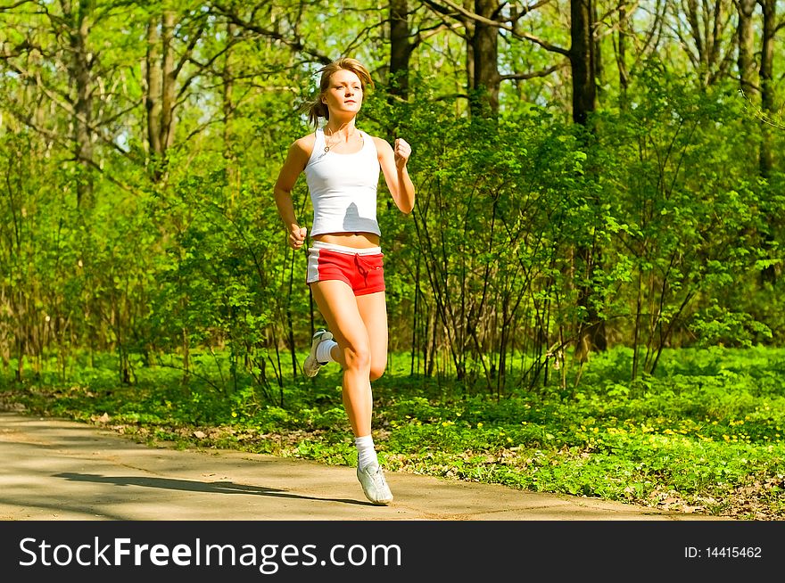 Young woman running in park. Young woman running in park