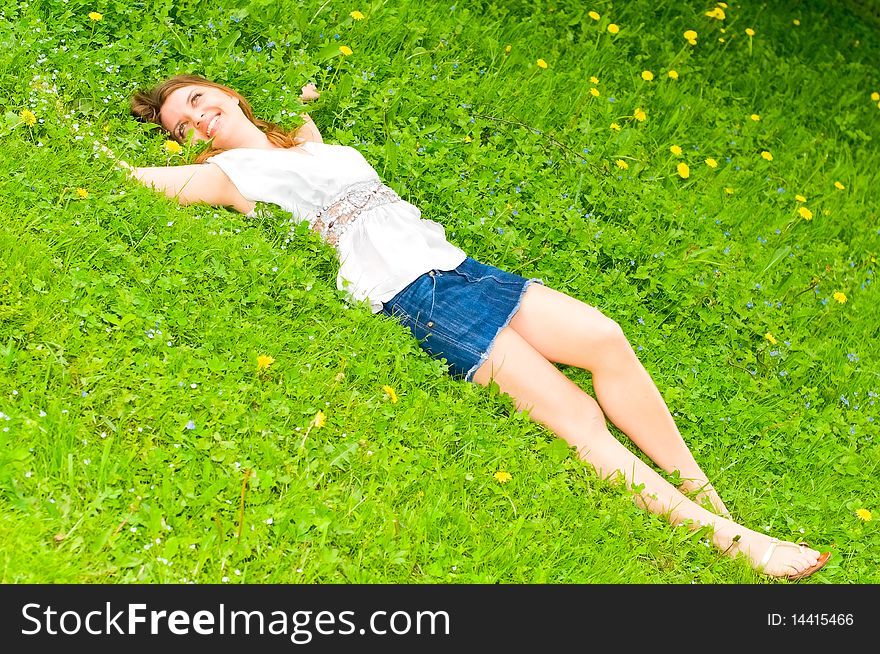 Young smiling woman resting on meadow. Young smiling woman resting on meadow