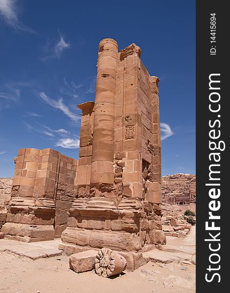 The main avenue of the ancient Nabotean city of Petra, Jordan, with carved tombs on the cliff face in the distance