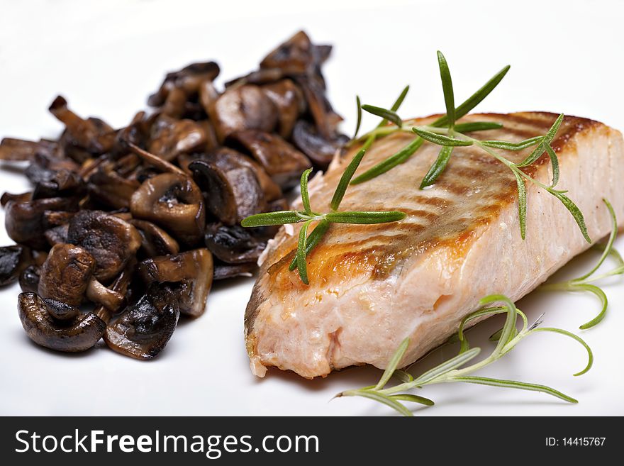 Grilled fish, salmon steak with mushrooms