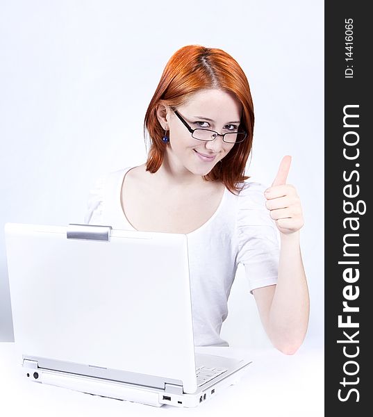 Red-haired girl with white notebook. Studio shot.