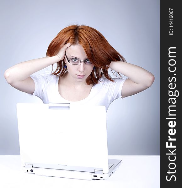 Red-haired girl with white notebook.