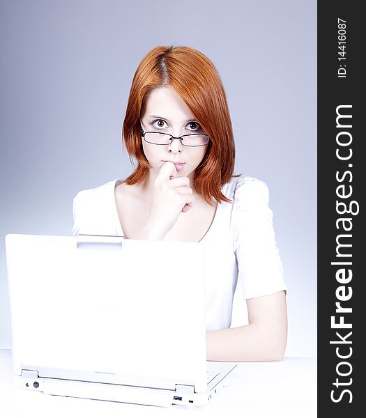 Red-haired girl with white notebook.