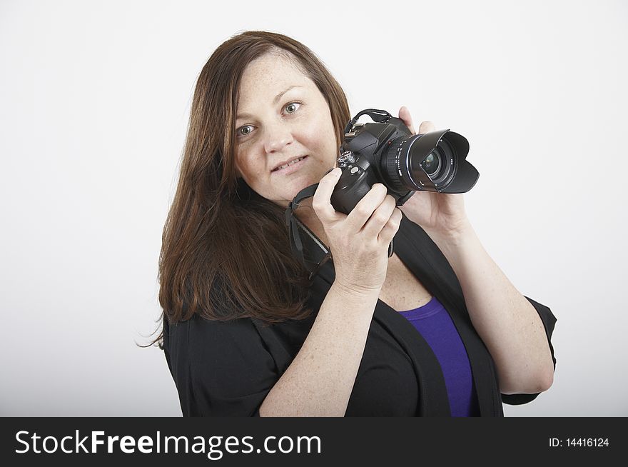 Head shot of a woman holding up a SLR camera. Head shot of a woman holding up a SLR camera