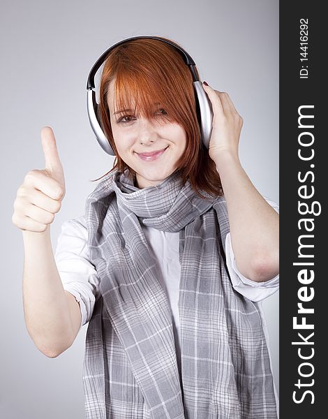 Girl with modern headphones show hand OK