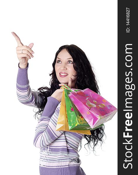 Charming young brunette holding colorful shopping bags. Charming young brunette holding colorful shopping bags