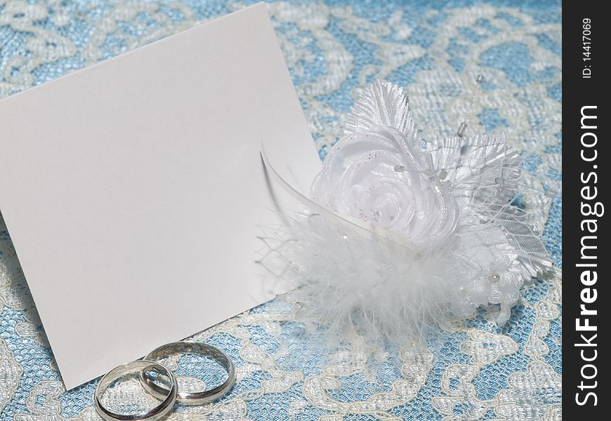 White card for congratulation on a background from blue  silk and white lace. White card for congratulation on a background from blue  silk and white lace