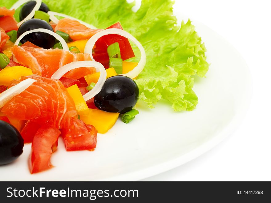 Vegetable salad with salmon isolated on white, the focus at the center of plates