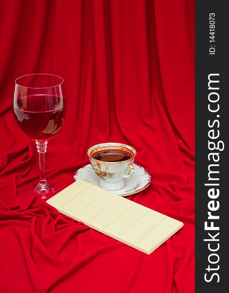 White chocolate, coffee and wine on a red background. White chocolate, coffee and wine on a red background