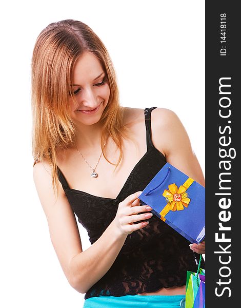 Picture of a beautiful young lady which looking into packets with a gift on white background. Picture of a beautiful young lady which looking into packets with a gift on white background.