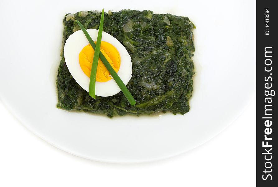 Sauteed spinach and egg isolated on white