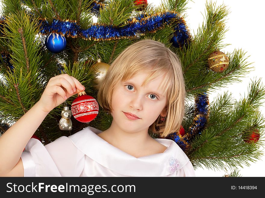 Nice girl decorates a Christmas tree