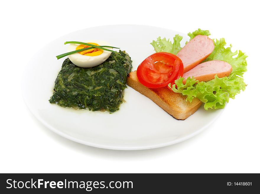 Sauteed spinach, egg and sandwich for breakfast isolated on white