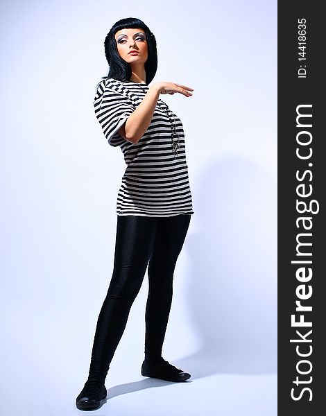 Attractive fashion woman posing in a striped top. Attractive fashion woman posing in a striped top