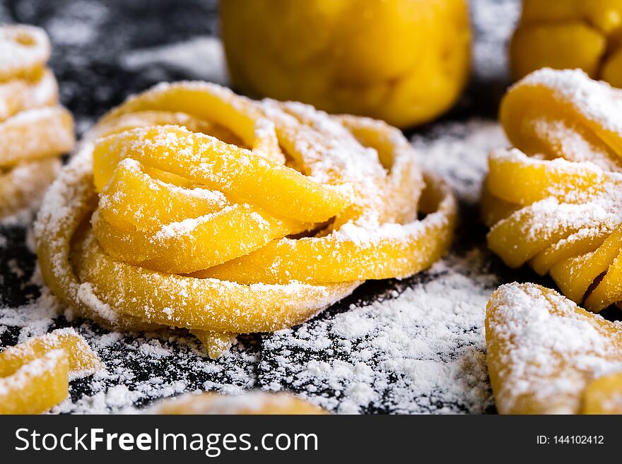 pasta with pasta ingredients on the dark wooden table top view