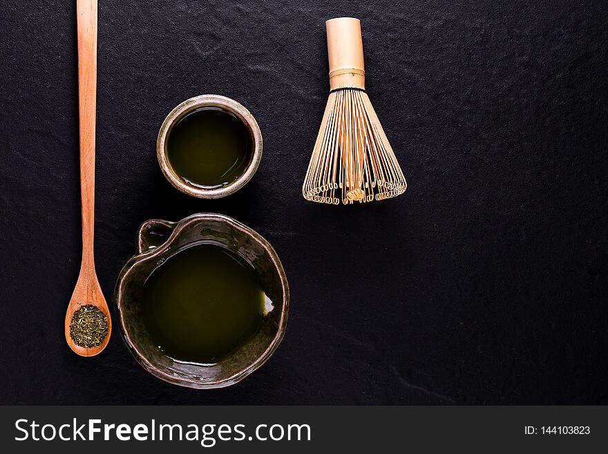 Top view of green tea matcha in a bowl on wooden surface