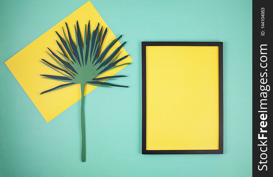 Decorative wooden tropical leaves and empty frame