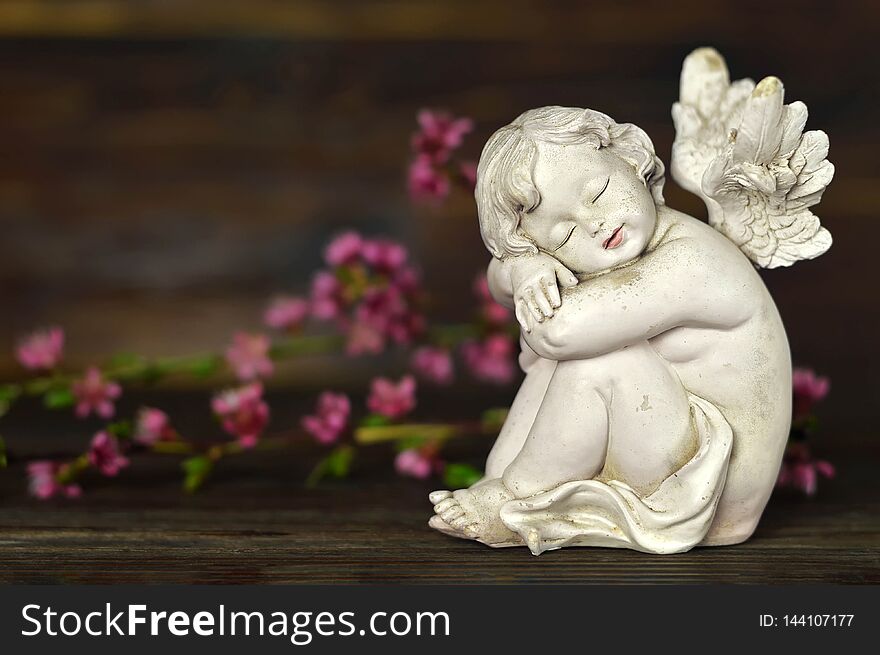 Little guardian angel and spring flowers