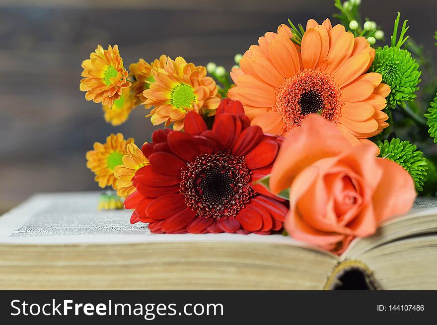 Mothers Day bouquet of flowers on open book. Mothers Day bouquet of flowers on open book