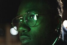 Retro Neon Portrait Of An African American. Black Man With Modern Glasses Royalty Free Stock Image