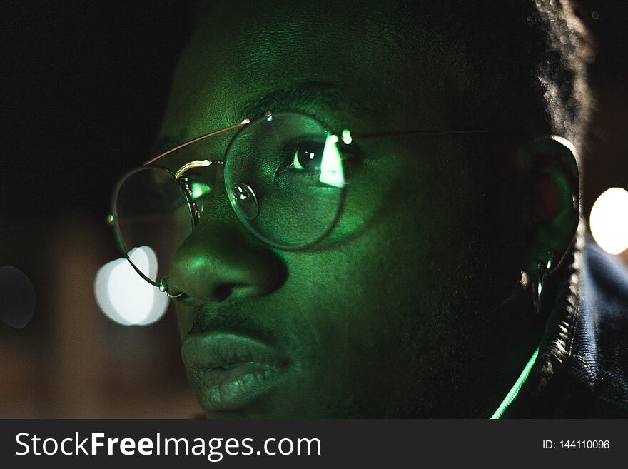 Retro neon portrait of an African American. Black man with modern glasses