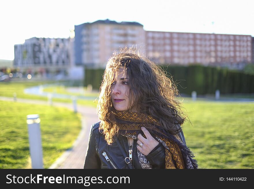 Winter beauty woman portraits, walking in city with scarf and leather jacket. Winter beauty woman portraits, walking in city with scarf and leather jacket