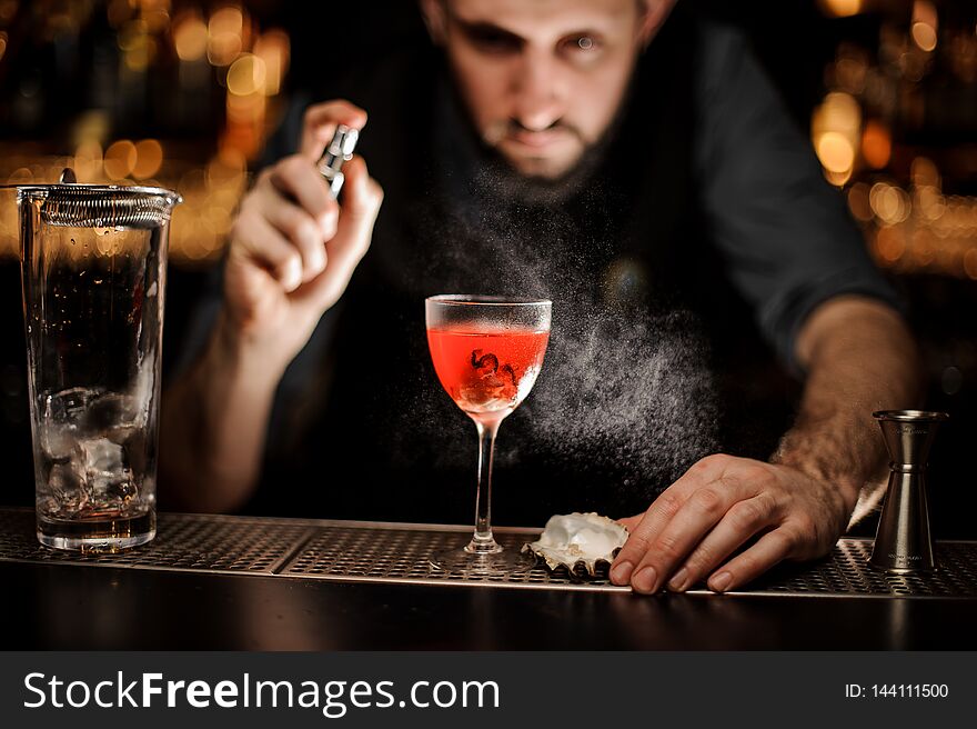 Bartender Spraying On The Delicious Transparent Red Cocktail In The Glass