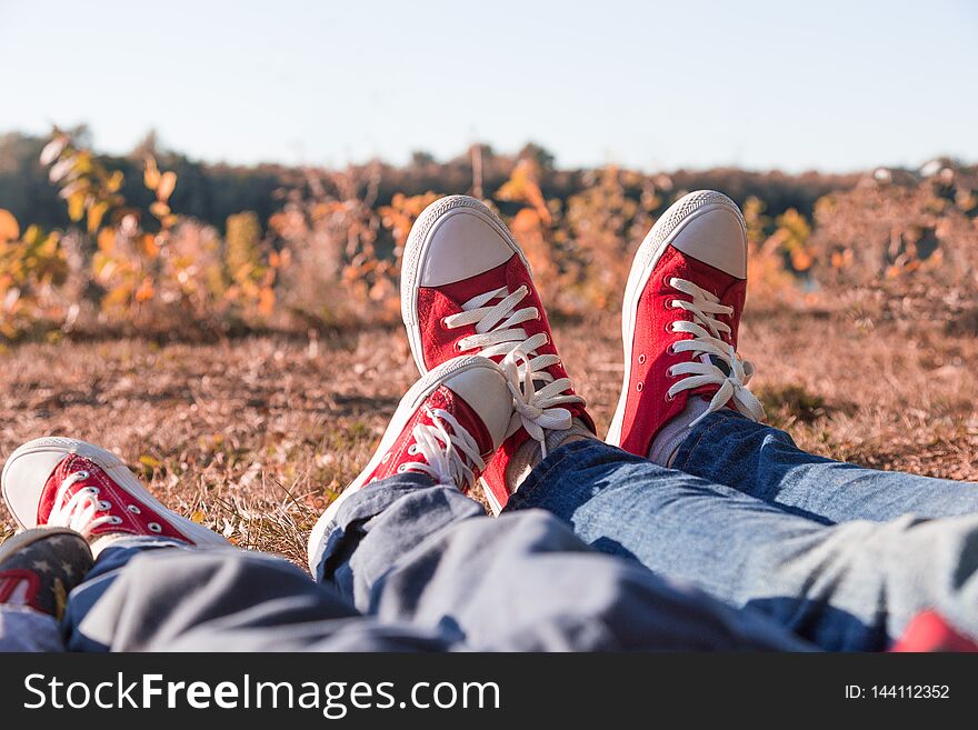 Young happy family with childrens having fun in nature. Young parents are resting on a picnic