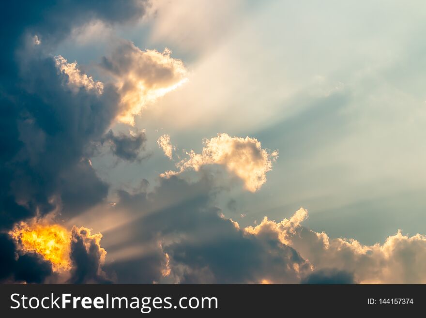 Abstract background, dark cumulonimbus and stormy clouds, dramatic sky, with sunlight breaking through clouds, rim light. Abstract background, dark cumulonimbus and stormy clouds, dramatic sky, with sunlight breaking through clouds, rim light