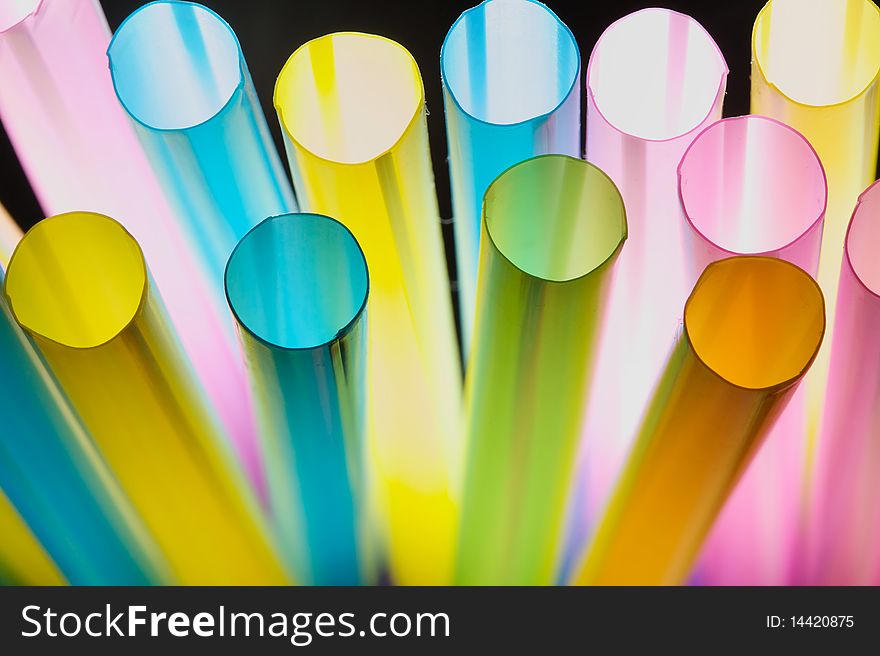 Colorful straw in the isolated black background. Colorful straw in the isolated black background.
