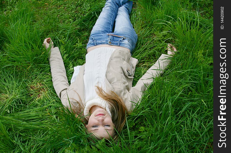 Girl lying in tall grass