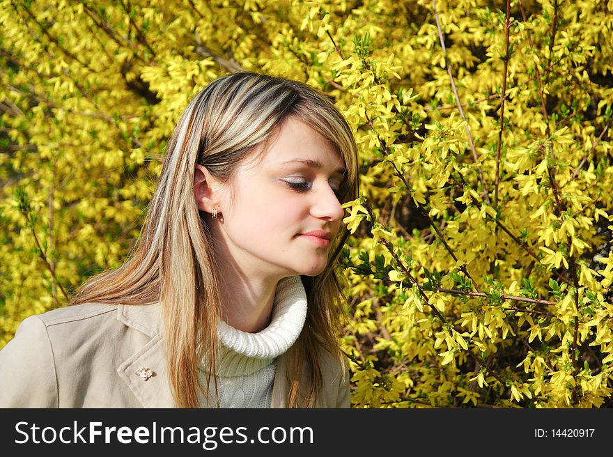 Girl smelling yellow flowers hovering. Girl smelling yellow flowers hovering