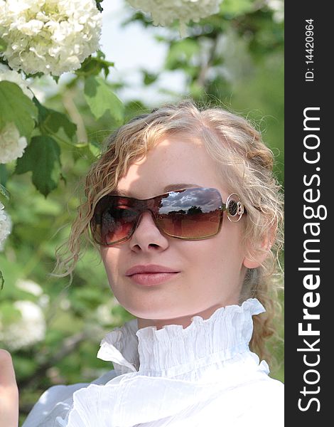 Blonde girl near the lilac bush in the spring. Blonde girl near the lilac bush in the spring