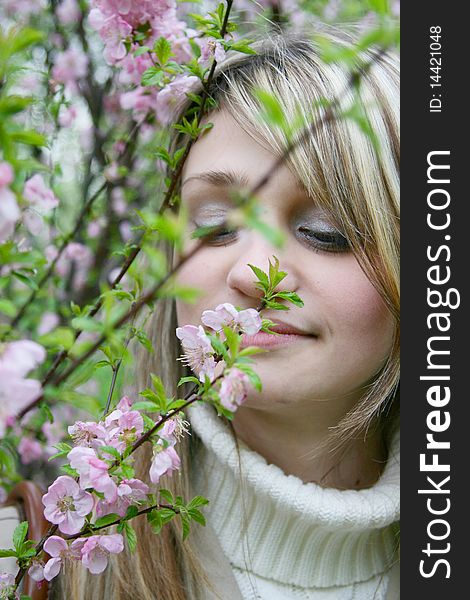 Girl smelling violet flowers hovering. Girl smelling violet flowers hovering