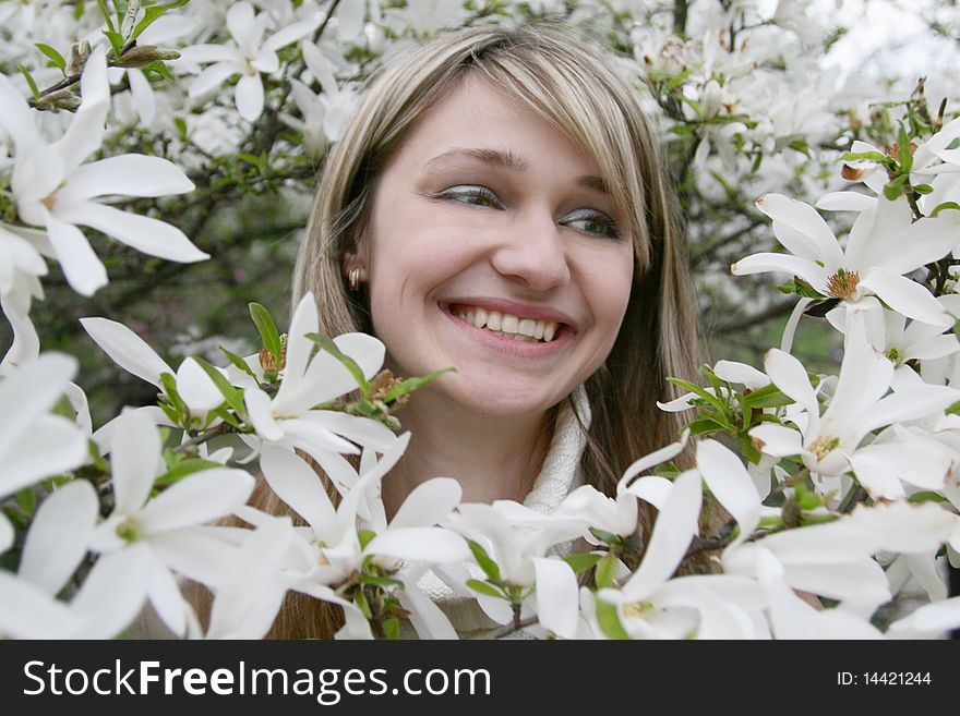 Young girl with a smile among the flowers. Young girl with a smile among the flowers