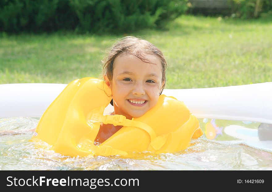 Girl in the rescue Life buoys floating in the pool