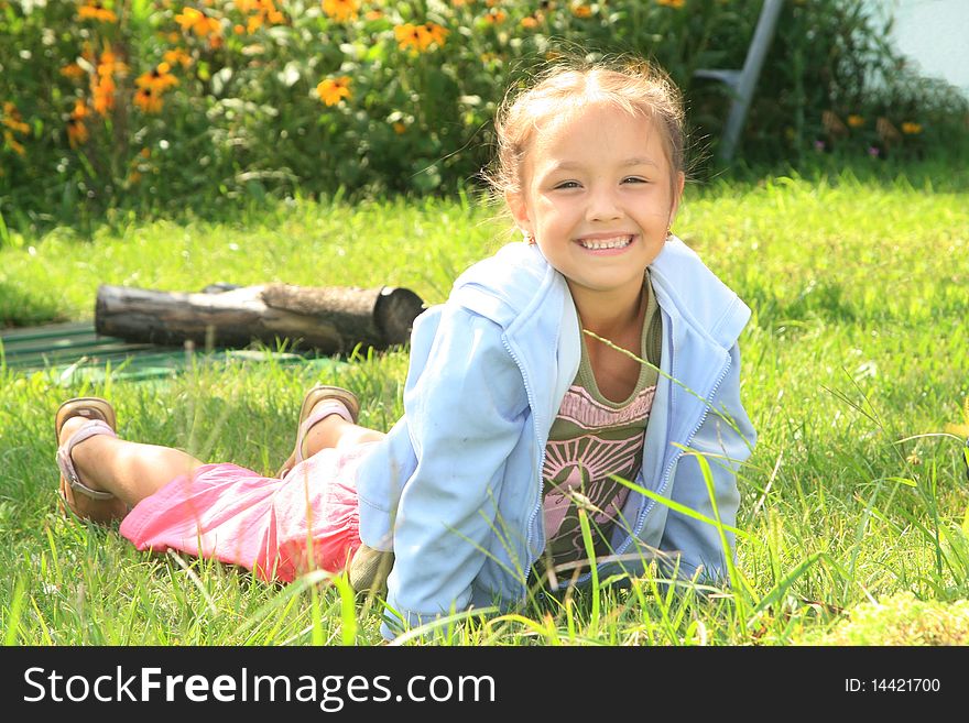 Young girl lying on the grass and smiling. Young girl lying on the grass and smiling