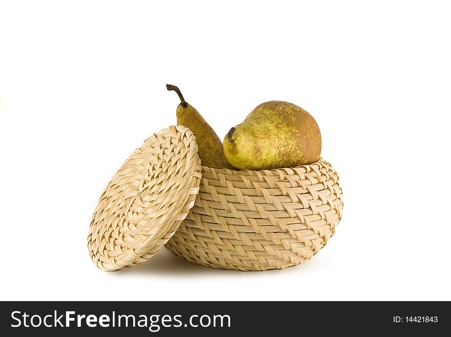 Two green pears in a straw basket on a white background