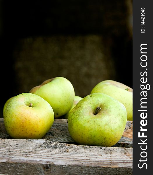 An image of juicy green apples on wooden bars