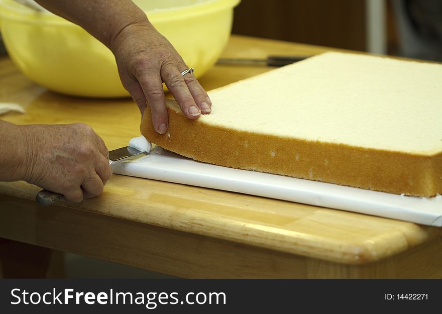 Icing is applied between the board and cake layer to firm it into place. Icing is applied between the board and cake layer to firm it into place