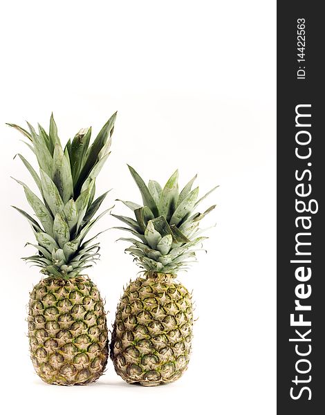 Two pineapples on white background