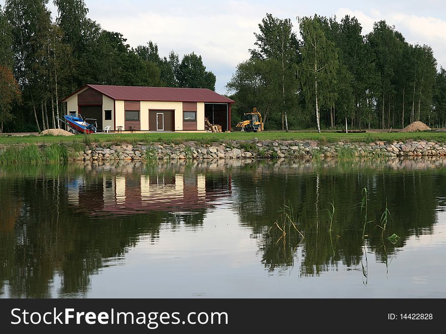 Shed with tractor and boat on a lake