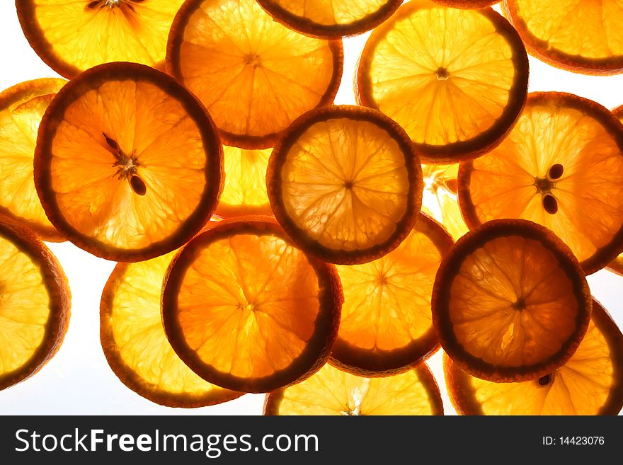 Cut segments of an orange on a white background. Cut segments of an orange on a white background.