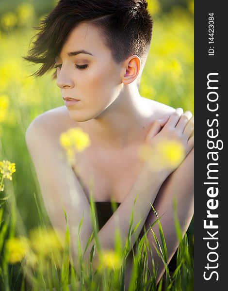 Sensual young girl surrounded by yellow flowers. Sensual young girl surrounded by yellow flowers